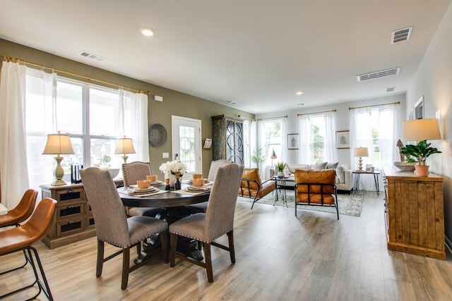 dining space with light hardwood / wood-style floors