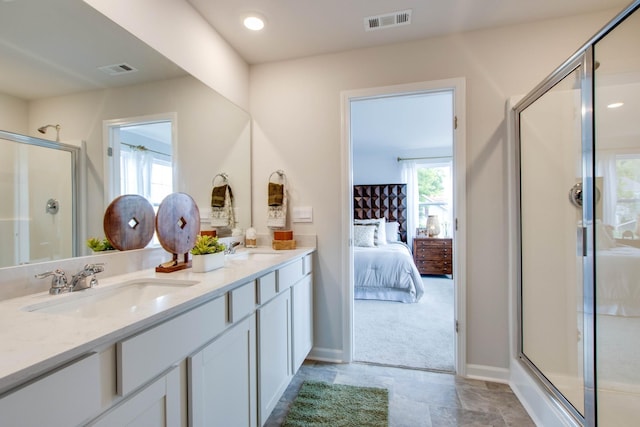 bathroom featuring vanity and a shower with shower door