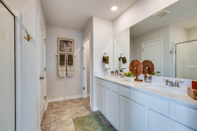 bathroom featuring vanity and a shower with shower door