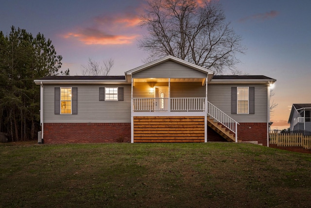 view of front of property with a lawn and covered porch