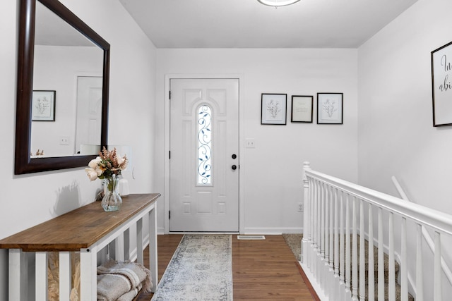 entryway with dark hardwood / wood-style flooring