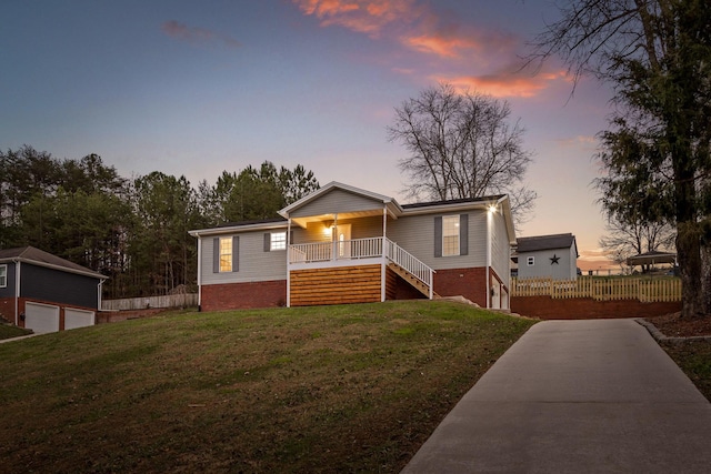 view of front of home with a lawn and covered porch