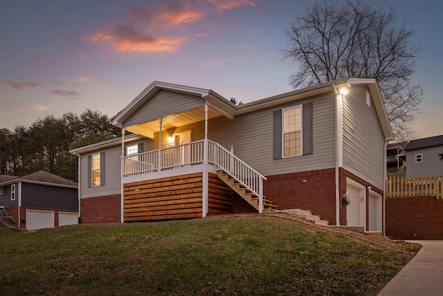 view of front of house with a yard and a porch