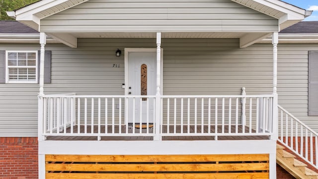 view of exterior entry with covered porch