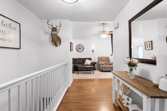 hallway with hardwood / wood-style floors