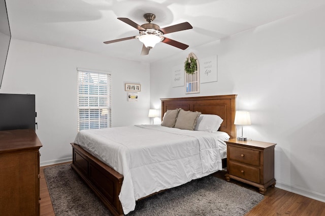 bedroom with dark hardwood / wood-style floors and ceiling fan