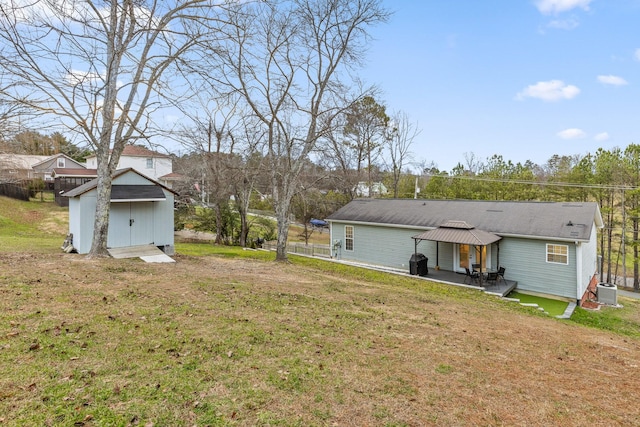 back of house with a gazebo, a storage unit, a patio, and a lawn