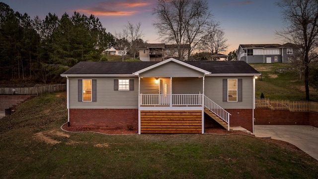 view of front of property featuring a porch and a lawn