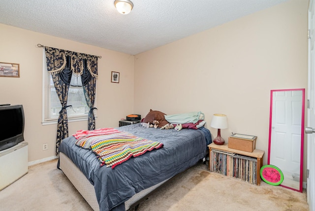 carpeted bedroom with a textured ceiling