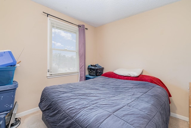 bedroom featuring a textured ceiling and carpet flooring