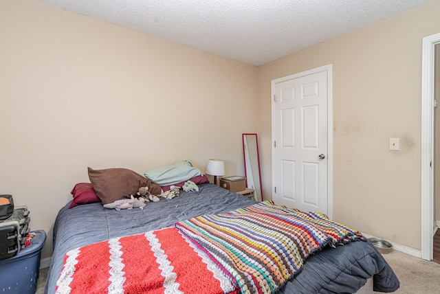 bedroom with a textured ceiling and carpet flooring