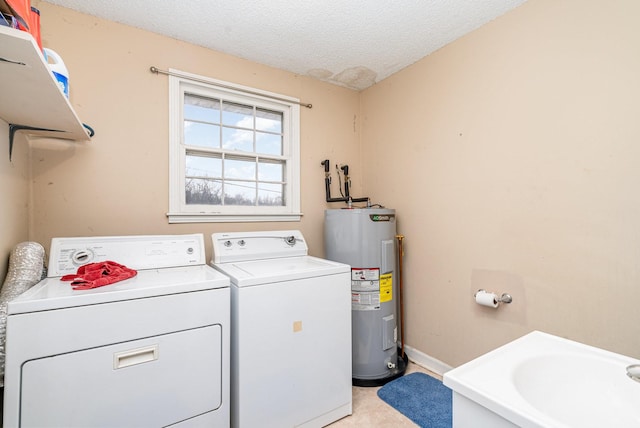 clothes washing area with a textured ceiling, washer and clothes dryer, electric water heater, and sink