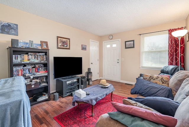 living room featuring a textured ceiling and hardwood / wood-style flooring