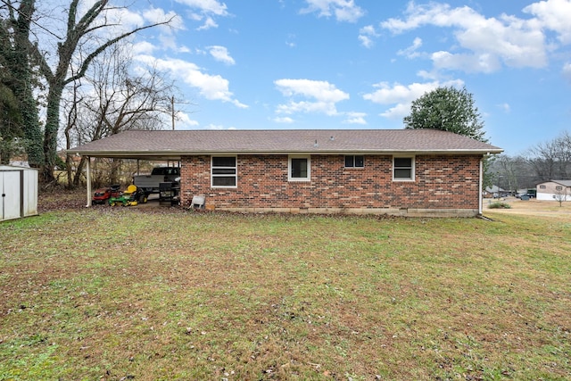 back of property with a storage shed, a lawn, and a carport