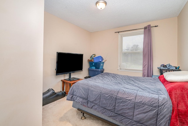 carpeted bedroom featuring a textured ceiling