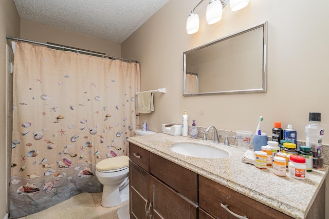 bathroom with a textured ceiling, toilet, walk in shower, and vanity