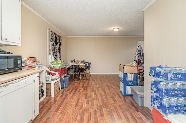 recreation room featuring dark wood-type flooring, crown molding, and a textured ceiling