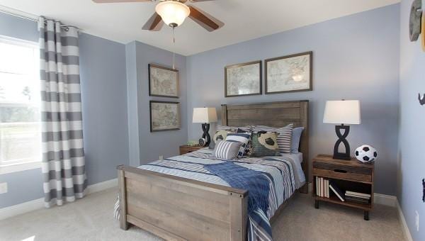 bedroom featuring ceiling fan and light carpet