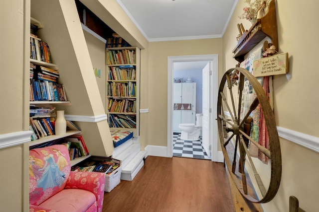 hall featuring wood-type flooring and crown molding