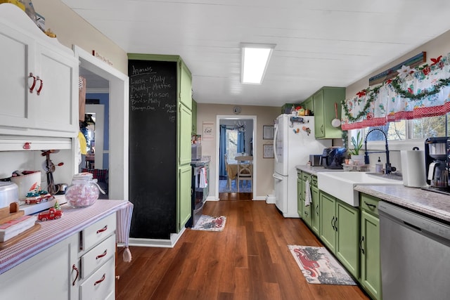 kitchen with dark hardwood / wood-style flooring, stainless steel appliances, green cabinets, and sink