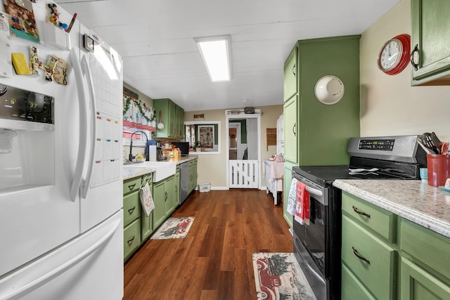 kitchen featuring dark wood-type flooring, sink, stainless steel appliances, and green cabinetry