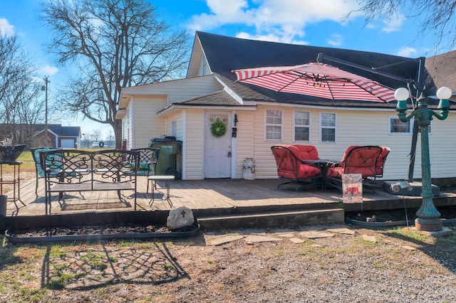 back of house featuring a wooden deck