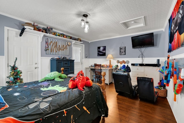 bedroom with a textured ceiling, wood-type flooring, and crown molding