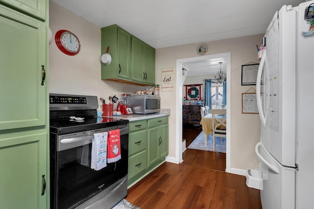 kitchen featuring green cabinets, dark hardwood / wood-style floors, and appliances with stainless steel finishes