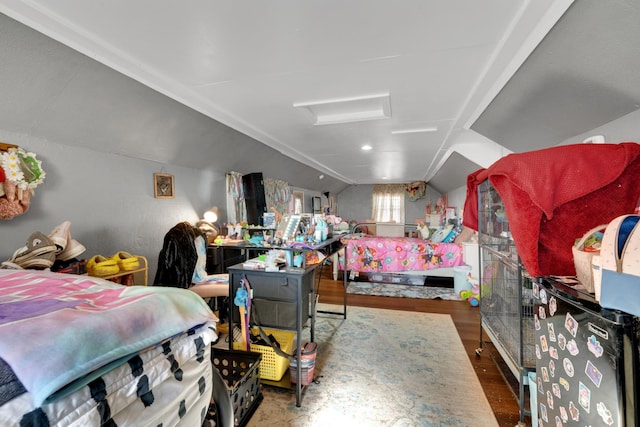 bedroom with wood-type flooring and vaulted ceiling