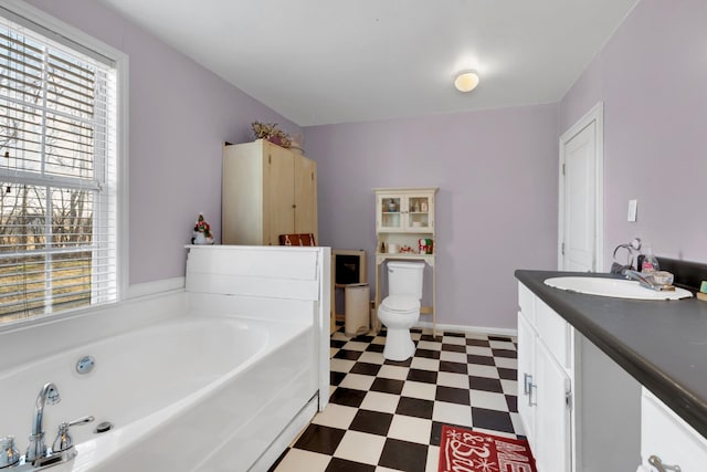 bathroom featuring vanity, toilet, and a bath