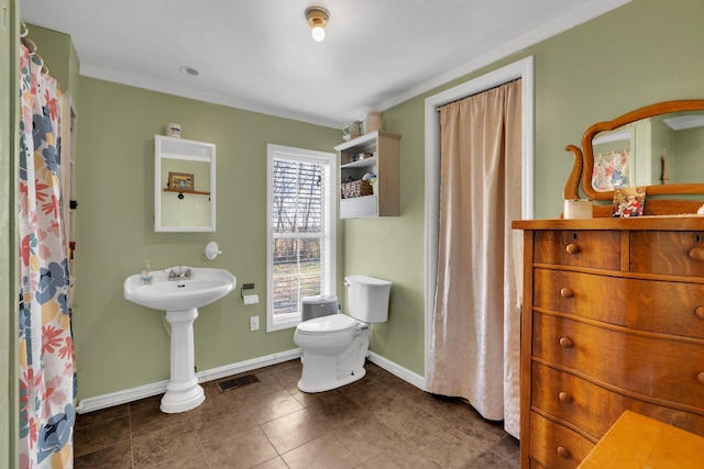 bathroom featuring toilet and crown molding