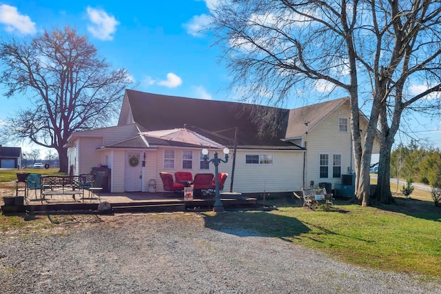 view of front of home featuring a deck and a front lawn