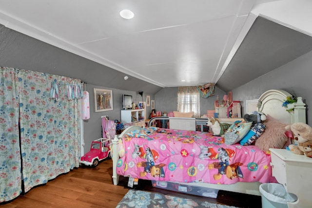 bedroom featuring wood-type flooring and vaulted ceiling