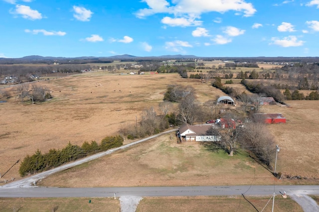 drone / aerial view featuring a mountain view and a rural view