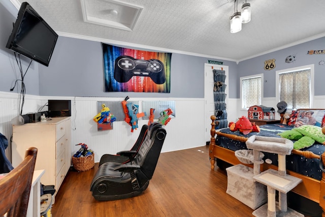 bedroom with dark wood-type flooring, a textured ceiling, and ornamental molding