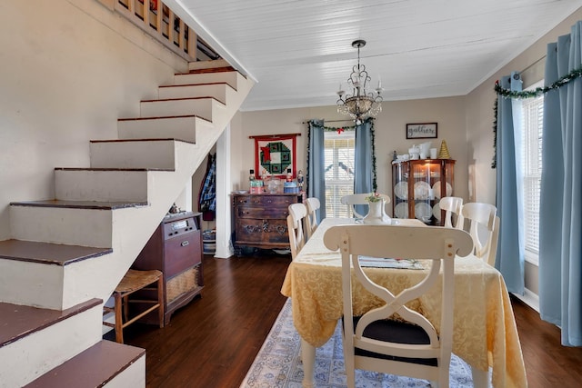 dining room with an inviting chandelier and dark wood-type flooring