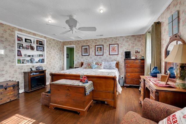 bedroom with ceiling fan, dark hardwood / wood-style flooring, ornamental molding, and a textured ceiling