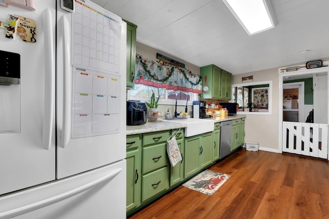 kitchen with dark hardwood / wood-style flooring, stainless steel dishwasher, sink, white refrigerator with ice dispenser, and green cabinetry