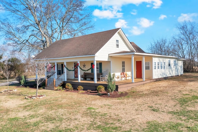 farmhouse-style home with covered porch and a front lawn