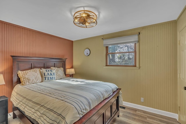 bedroom featuring baseboards and light wood-style floors