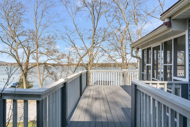 wooden terrace with a water view and a sunroom