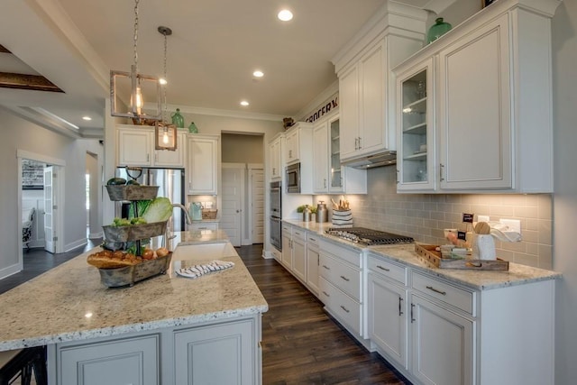 kitchen with a center island, white cabinetry, and sink