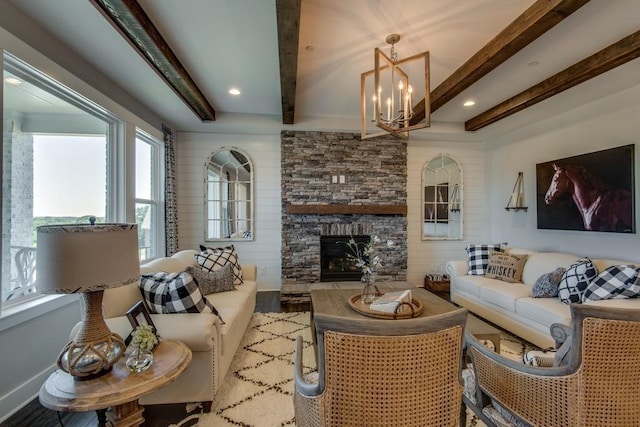 living room with beamed ceiling, a fireplace, and a notable chandelier