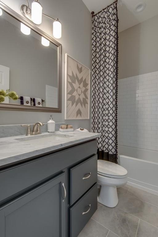 full bathroom with tile patterned flooring, vanity, toilet, and shower / bathtub combination with curtain