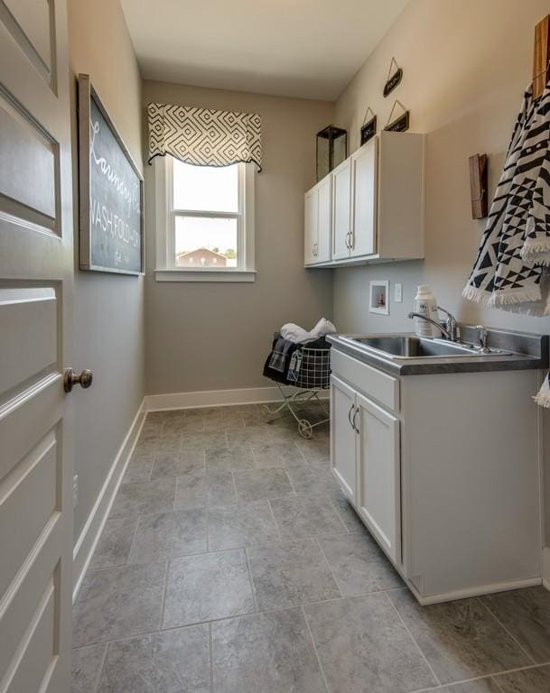 laundry room featuring hookup for a washing machine, cabinets, and sink