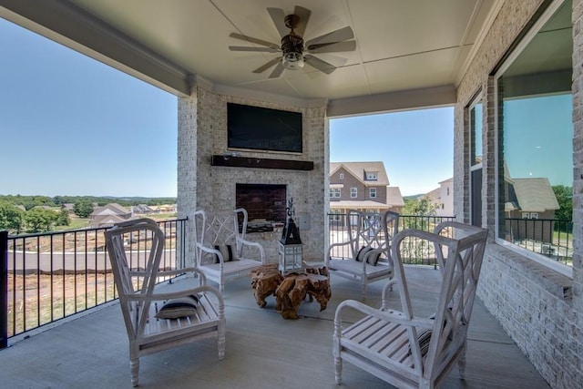 balcony with ceiling fan and an outdoor brick fireplace