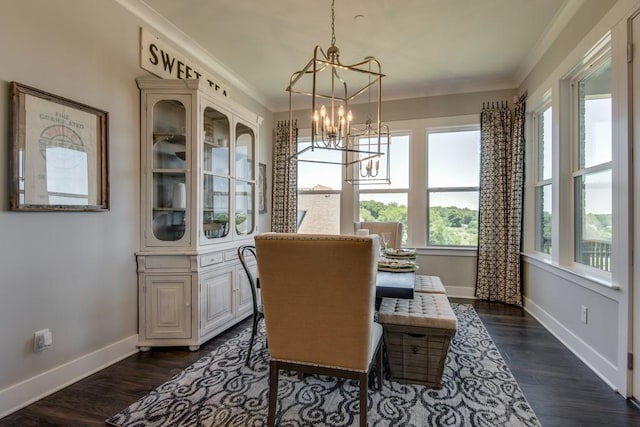 dining room with dark wood-type flooring, a notable chandelier, and ornamental molding