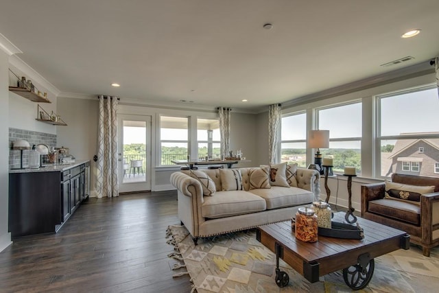 living room with dark wood-type flooring and crown molding