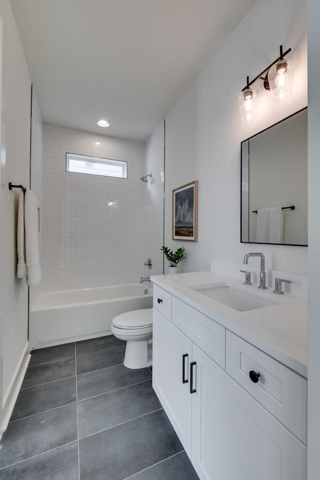 full bathroom featuring vanity, toilet, tiled shower / bath, and tile patterned floors