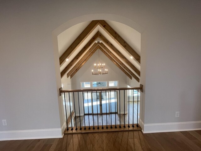 room details featuring beamed ceiling, a chandelier, and hardwood / wood-style flooring